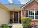 Inviting front entrance with a black door, decorative plants, and visible house number at 1820 Irish Lake Ln, Indianapolis, IN 46239