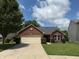 Charming brick home featuring an attached two-car garage and well-maintained landscaping in a residential area at 1820 Irish Lake Ln, Indianapolis, IN 46239