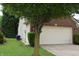Side view of a home featuring a white garage door, vinyl siding, and an air conditioning unit at 1820 Irish Lake Ln, Indianapolis, IN 46239