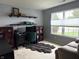 Bright home office with a comfortable sitting area, functional desk, and plenty of natural light from the windows at 1820 Irish Lake Ln, Indianapolis, IN 46239