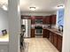 Spacious kitchen featuring stainless steel appliances, ample counter space, and tile flooring at 1820 Irish Lake Ln, Indianapolis, IN 46239