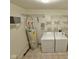 Functional laundry room with washer, dryer, water heater, and ample shelving for storage and organization at 1820 Irish Lake Ln, Indianapolis, IN 46239