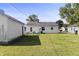 Spacious backyard with a detached garage, featuring a well-maintained lawn and patio furniture for outdoor enjoyment at 206 Allen Ln, Greenfield, IN 46140