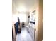 Clean bathroom with marble-look flooring, wainscoting, and a new vanity at 206 Allen Ln, Greenfield, IN 46140