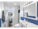 Bright and clean bathroom with white fixtures, a modern mirror, and fresh blue accents at 206 Allen Ln, Greenfield, IN 46140