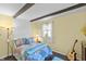 Cozy bedroom with exposed beam ceiling, bright yellow walls and plenty of natural light at 206 Allen Ln, Greenfield, IN 46140