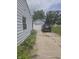 View of driveway and detached garage alongside house showing exterior siding at 206 Allen Ln, Greenfield, IN 46140