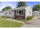 Well-kept single-story home with a manicured lawn, flower beds, and a detached garage offering a welcoming curb appeal at 206 Allen Ln, Greenfield, IN 46140