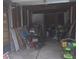 Cluttered garage space featuring lawn mower and supplies, with ample potential for storage at 206 Allen Ln, Greenfield, IN 46140