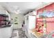 Bright kitchen with white cabinets, stainless steel sink, and eat-in dining set with natural light at 206 Allen Ln, Greenfield, IN 46140