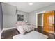 Bedroom featuring a plush rug, gray walls and a light pink comforter at 211 N County Line Rd, , IN 47272