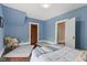 Blue bedroom with a soft rug, a cozy chair and a wooden door at 211 N County Line Rd, , IN 47272