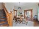 Elegant dining room with a hardwood floor, a stylish light fixture and stairs in view at 211 N County Line Rd, , IN 47272