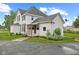 Side view of a white home featuring well-kept grounds at 211 N County Line Rd, , IN 47272