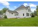 Rear exterior view of a white two-story home with green lawn and garden at 211 N County Line Rd, , IN 47272