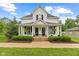 Inviting two-story home with covered porch, hanging swing, and landscaped front yard at 211 N County Line Rd, , IN 47272