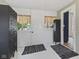 Hallway featuring white wooden floors, vintage black lockers, neutral window coverings and a doorway leading to another room at 211 N County Line Rd, , IN 47272
