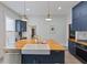 Gorgeous kitchen with butcher block island, stainless steel appliances, and custom cabinetry at 211 N County Line Rd, , IN 47272