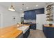 Modern kitchen with custom cabinetry, butcher block island and stainless steel appliances at 211 N County Line Rd, , IN 47272