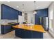 Stylish kitchen with custom cabinets, butcher block island and stainless steel appliances at 211 N County Line Rd, , IN 47272