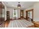 Open living room with hardwood floors, area rug, wood trim and natural light at 211 N County Line Rd, , IN 47272