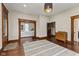 Spacious living room with hardwood floors, area rug, and views to another room at 211 N County Line Rd, , IN 47272