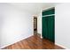 Bedroom featuring neutral walls and wood floors, plus closet with curtain and interior door at 220 E Tilden Dr, Brownsburg, IN 46112