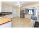 Open-concept kitchen with stainless steel refrigerator and view to living area at 220 E Tilden Dr, Brownsburg, IN 46112