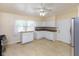 Bright kitchen with tiled floors, white cabinetry, and stainless steel refrigerator at 220 E Tilden Dr, Brownsburg, IN 46112