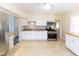Modern kitchen with white cabinets, stainless steel appliances, and neutral countertops at 220 E Tilden Dr, Brownsburg, IN 46112