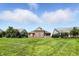 Spacious, well-kept backyard featuring a brick home and lush green lawn on a sunny day at 2251 Somerset Dr, Franklin, IN 46131