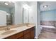 This bathroom features a double vanity, a soaking tub, a private toilet, and ample natural light at 2251 Somerset Dr, Franklin, IN 46131