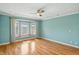 Sun-drenched bedroom features a cozy window seat, hardwood floors, and a modern ceiling fan at 2251 Somerset Dr, Franklin, IN 46131
