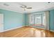 Stylish bedroom offers hardwood flooring, a lighted ceiling fan, and a charming window seat with great natural light at 2251 Somerset Dr, Franklin, IN 46131