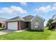 Attractive home featuring a combination of brick and stone facade, a well-kept lawn and a two-car garage at 2251 Somerset Dr, Franklin, IN 46131