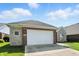 Two-car garage with beautiful stone and brick facade, enhanced curb appeal, and well-kept lawn at 2251 Somerset Dr, Franklin, IN 46131
