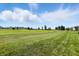 Picturesque golf course view with manicured greens and beautiful houses against a cloudy blue sky at 2251 Somerset Dr, Franklin, IN 46131
