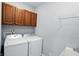 Laundry room boasts upper cabinets and modern washer and dryer at 2251 Somerset Dr, Franklin, IN 46131