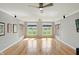 Bright living area with hardwood floors, three large picture windows, and modern ceiling fans at 2251 Somerset Dr, Franklin, IN 46131