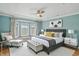 Spacious main bedroom featuring a tray ceiling, stylish furnishings, and a cozy bay window at 2251 Somerset Dr, Franklin, IN 46131