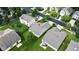 Overhead view of a home with a spacious lawn, patio seating, and lush green surroundings in a residential area at 2253 Bridlewood Dr, Franklin, IN 46131