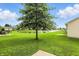 The backyard has a large tree and view of the pond at 2253 Bridlewood Dr, Franklin, IN 46131