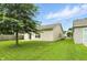 A home's backyard with a large grassy area and a partially covered patio at 2253 Bridlewood Dr, Franklin, IN 46131