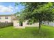 Backyard featuring green grass, a patio, a tree, and a view of the home's back exterior at 2253 Bridlewood Dr, Franklin, IN 46131
