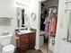 Bathroom featuring a vanity with dark wood cabinets, updated fixtures, and closet with ample storage space at 2253 Bridlewood Dr, Franklin, IN 46131