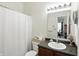 Bright bathroom with a white shower curtain, a vanity with dark wood cabinets, and good lighting at 2253 Bridlewood Dr, Franklin, IN 46131