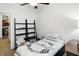 Bedroom featuring a bed with white floral-themed bedding, with shelving, with view into the kitchen at 2253 Bridlewood Dr, Franklin, IN 46131