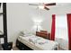 Well-lit bedroom with soft lighting, a bed with white floral themed bedding, and red curtains at 2253 Bridlewood Dr, Franklin, IN 46131