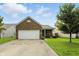 Charming brick home featuring a two-car garage and a well-maintained front lawn at 2253 Bridlewood Dr, Franklin, IN 46131