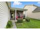 Charming front porch with comfortable seating, colorful flower accents, and inviting curb appeal at 2253 Bridlewood Dr, Franklin, IN 46131